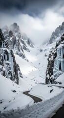 Dramatic Winter Wonderland: Serpentine Road Winding Through a Snow-Covered Mountain Valley Adorned with Majestic Peaks and Glistening Icicles Under a Cloud-Filled Sky.