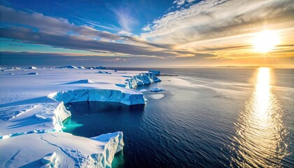 Aerial View of Antarctic Icebergs and Ocean Under a Dramatic Sunset Sky