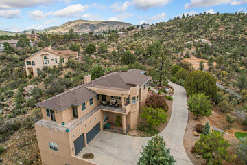 A quaint house is situated atop a hill right in the middle of a vast desert