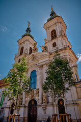 Graz, Austria – July 22, 2025: Exterior view of the Mariahilferkirche, a prominent Baroque-style Catholic church in Graz featuring twin towers and ornate statues on the façade.
