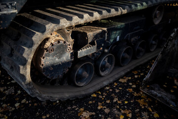 Detailed view of compact loader rubber track undercarriage with drive sprocket and support rollers showing terrain traction and engineering structure of tracked machinery