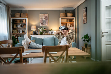 Man relaxing at home enjoying virtual reality experience