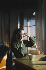 mature European woman work near the window