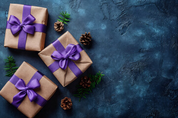 An elegant composition of three gift boxes tied with purple ribbons on a dark blue background. Pine branches and cones nearby create a cozy and festive winter atmosphere.