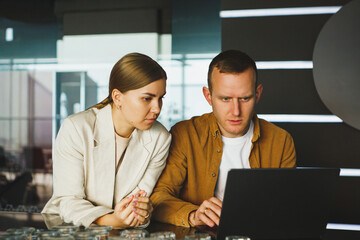 Couple works together at the open space. coworkers collaboration