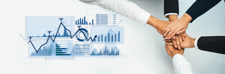 Hands come together in a symbol of teamwork and collaboration, set against financial charts...