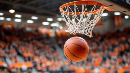 Fototapeta premium Basketball about to go through the hoop during a game