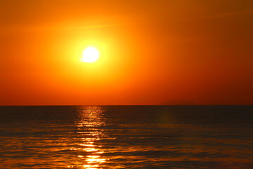 Stunning Sunset Over Calm Ocean Waters Reflecting Golden Light
