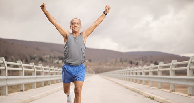 Senior man running on a bridge