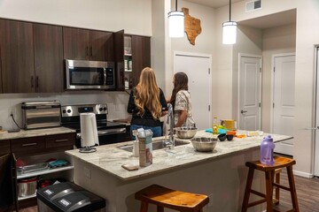 Modern Kitchen Scene with Two Friends Cooking Together
