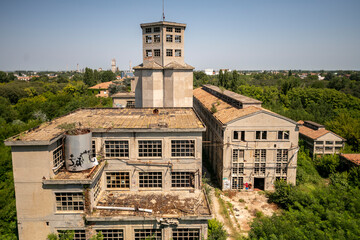 Abandoned distillery tower in Italy – circular industrial building with glass dome, steel beams, panoramic windows, decaying factory interior, urban exploration, post-industrial architecture