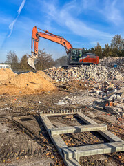 excavator demolishing debris at construction site, showcasing heavy machinery, surrounded by rubble...