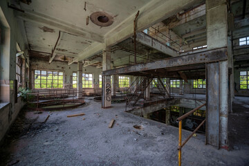 Abandoned distillery tower in Italy – circular industrial building with glass dome, steel beams, panoramic windows, decaying factory interior, urban exploration, post-industrial architecture