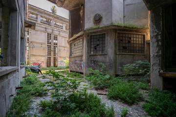 Abandoned distillery tower in Italy – circular industrial building with glass dome, steel beams, panoramic windows, decaying factory interior, urban exploration, post-industrial architecture