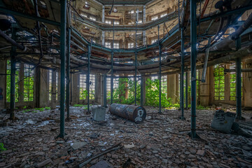 Abandoned distillery tower in Italy – circular industrial building with glass dome, steel beams, panoramic windows, decaying factory interior, urban exploration, post-industrial architecture