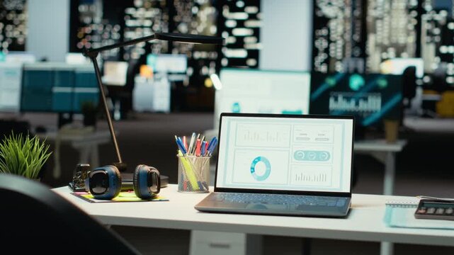 High end empty workspace features laptop with data charts for forecasting. Modern space set for corporate planning, analytics and performance indicators that drive organizational success.