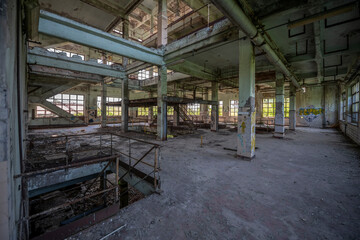 Abandoned distillery tower in Italy – circular industrial building with glass dome, steel beams, panoramic windows, decaying factory interior, urban exploration, post-industrial architecture
