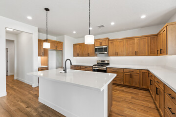 A kitchen with beautiful wooden cabinets and stylish white tops