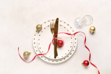 Beautiful table setting with Christmas balls on white background