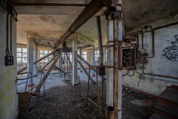 Abandoned distillery tower in Italy – circular industrial building with glass dome, steel beams, panoramic windows, decaying factory interior, urban exploration, post-industrial architecture