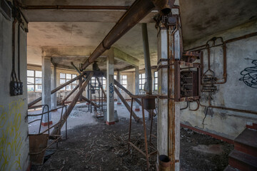 Abandoned distillery tower in Italy – circular industrial building with glass dome, steel beams, panoramic windows, decaying factory interior, urban exploration, post-industrial architecture