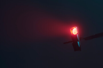Traffic light on a foggy night