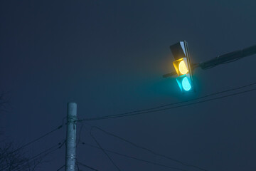 Traffic light on a foggy night