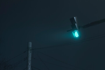 Traffic light on a foggy night
