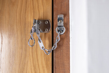 peeking through door chain, security check, suspicious moment, closeup indoor scene, safety concern, fear stranger, personal space, added door protection