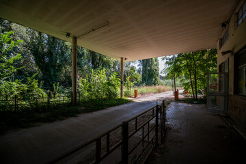 Abandoned distillery tower in Italy – circular industrial building with glass dome, steel beams, panoramic windows, decaying factory interior, urban exploration, post-industrial architecture