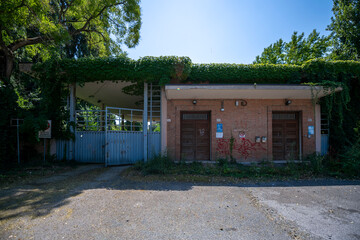 Abandoned distillery tower in Italy – circular industrial building with glass dome, steel beams, panoramic windows, decaying factory interior, urban exploration, post-industrial architecture
