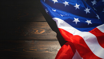 Image shows American flag with stars and stripes draped over dark wooden surface, creating patriotic and solemn atmosphere