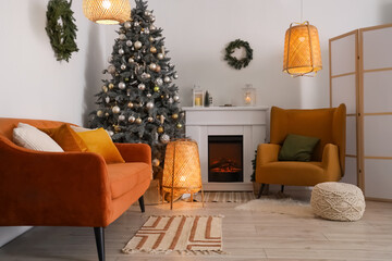 Interior of living room with fireplace, Christmas tree and glowing lamps