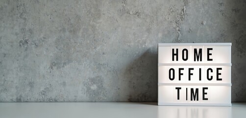Lightbox displays HOME OFFICE TIME text against grey concrete wall background. Modern workplace setup for remote work and productivity concepts. Focused work environment.