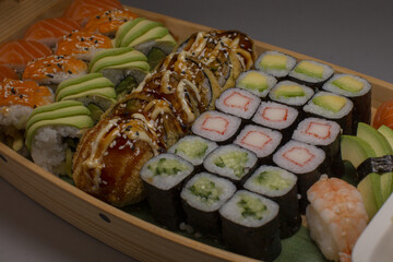 Sushi platter display, Elegant sushi assortment with garnishes displayed, Assorted sushi selection beautifully arranged with garnishes and side accompaniments