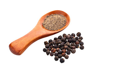Piper nigrum - Ground black pepper in a measuring spoon with whole peppercorns