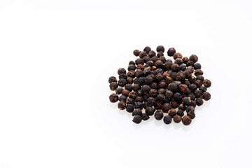 Piper nigrum - Black peppercorns on white background
