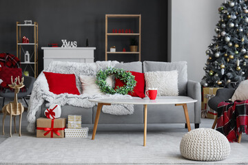 Interior of living room with Christmas mistletoe wreath on sofa and table