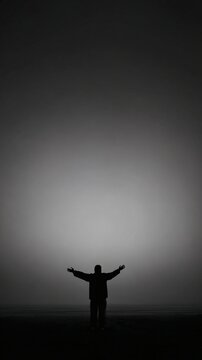 outstretched. A solitary silhouette against a misty backdrop, evoking a sense of quiet contemplation. wellbeing guides, coaching materials, designed for coaching and self-improvement content.