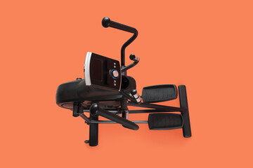 Modern elliptical machine on orange background, top view