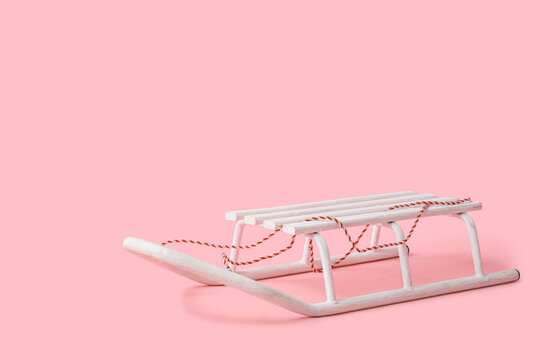 Empty sled on pink background