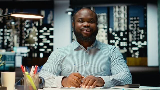 African american male advisor joining a web video call on laptop, engaged in discussion after hours. Professional man interacting with shareholders, adaptability in networking session. Camera B.