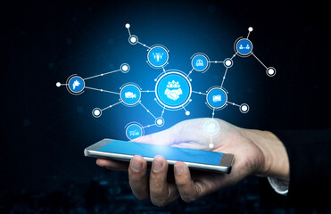 A close-up view of a hand holding a smartphone, surrounded by glowing digital network graphics, symbolizing technology, communication, and the digital future. Tessel