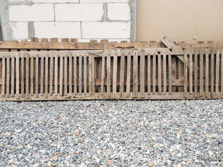 Old Wooden Slats Leaning Against a Construction Wall.