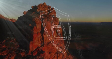 Displaying red cliff glowing at desert canyon dusk, with shield showing camera icon and code lines