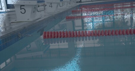 Resting starting blocks 5 and 4 on tiled lap pool deck, red lane floats, copy space