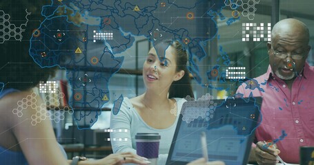 Speaking Korean woman gesturing at meeting table in office, with laptops, holographic data overlay