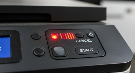 Close-up of black printer control panel with lit red indicators and buttons, including "Cancel" & "Start