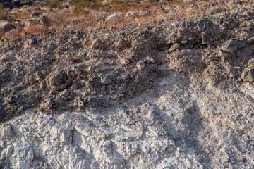 Charlie Brown Outcrop. Cutting or Cut (earthworks). Shoshone in Inyo County, California geology.  devitrified pumice tuff, welded tuff and vesicular vitrophyre. The volcanic rocks are cut by faults. 