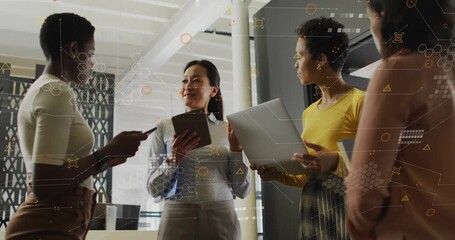 Female team lead swiping tablet and animating AR charts for business alignment, colleagues nodding - Powered by Adobe